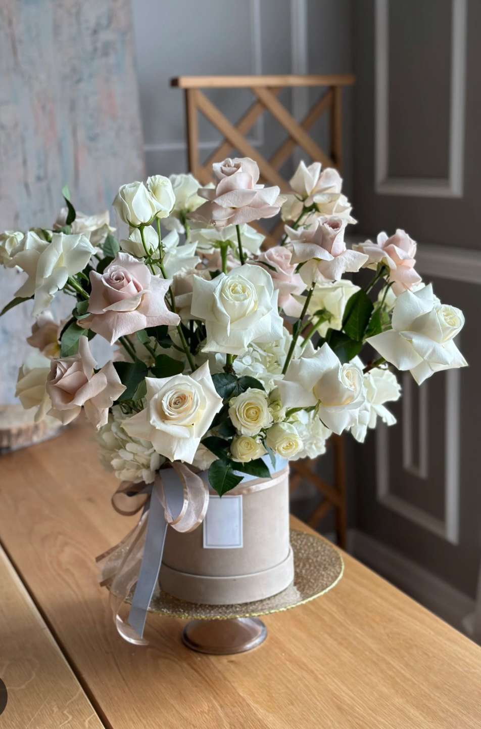 Screenshot Ultra Luxe Flower Box with white and blush roses, spray roses, and greenery arranged in a velvet box with satin ribbons for Valentine’s Day